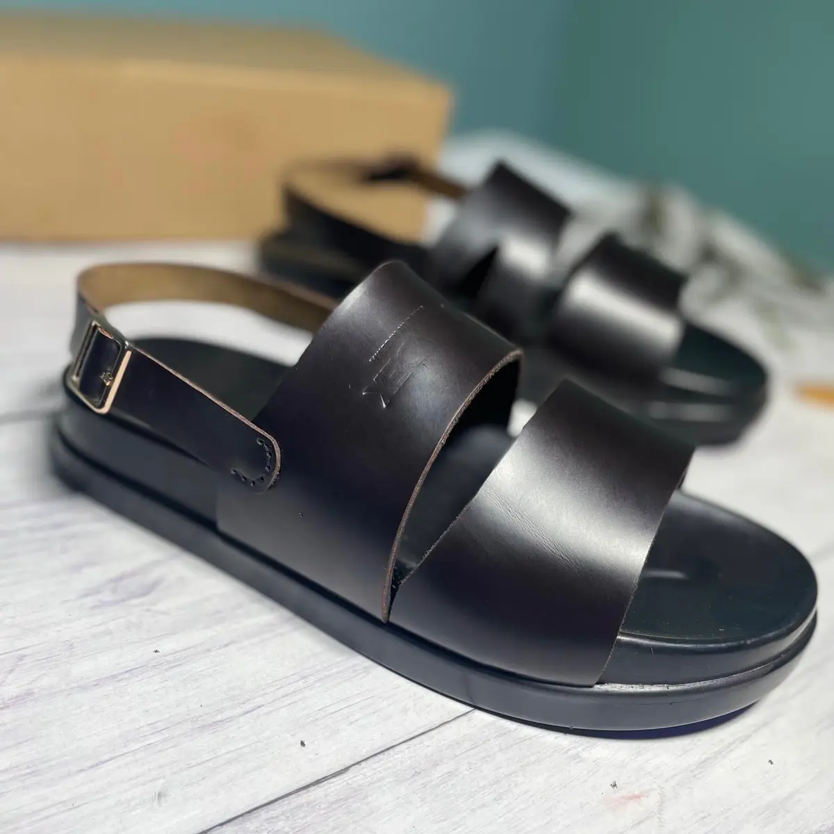 Elevated side view of a double-strap leather sandal for men