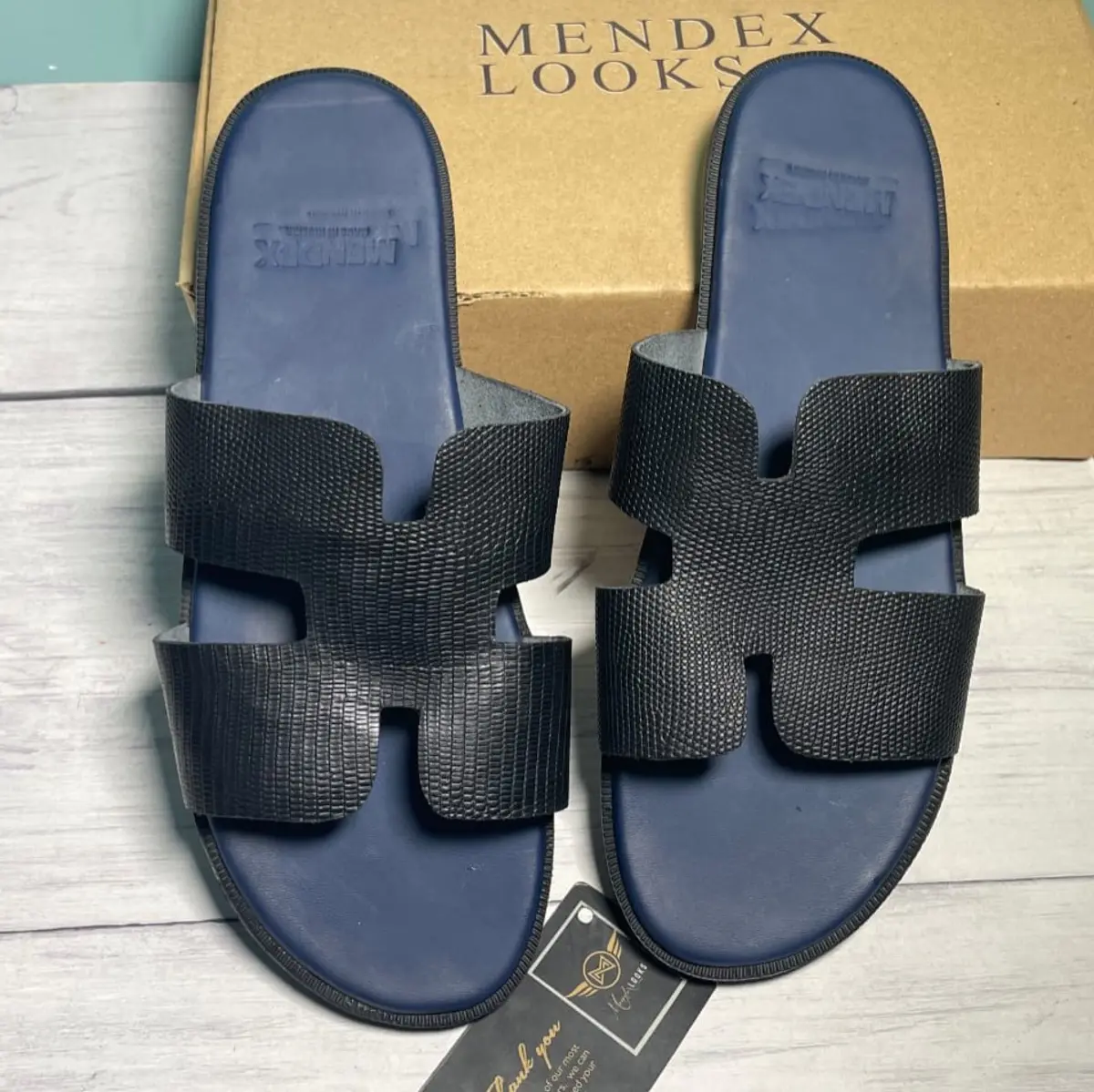 A pair of leather black slippers