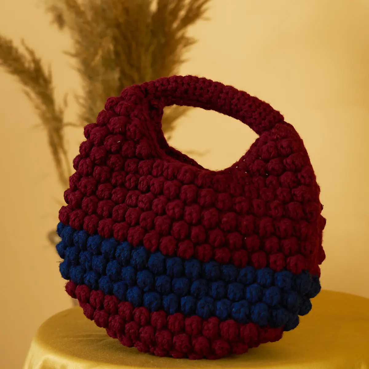 This petite knitted bag is the perfect blend of charm and functionality. Handcrafted with care, its compact size makes it ideal for carrying just the essentials — phone, keys, cards, and a touch of lipstick. Soft to the touch with a beautifully textured knit design, this bag adds a cozy, stylish accent to any outfit. Lightweight and easy to carry, it's your go-to accessory for casual outings, coffee dates, or minimalist everyday style.