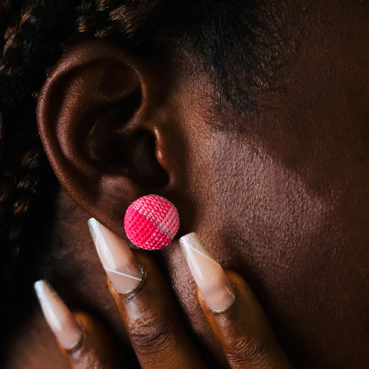 An African Handwoven Aso Oke Earrings on a Female Ear