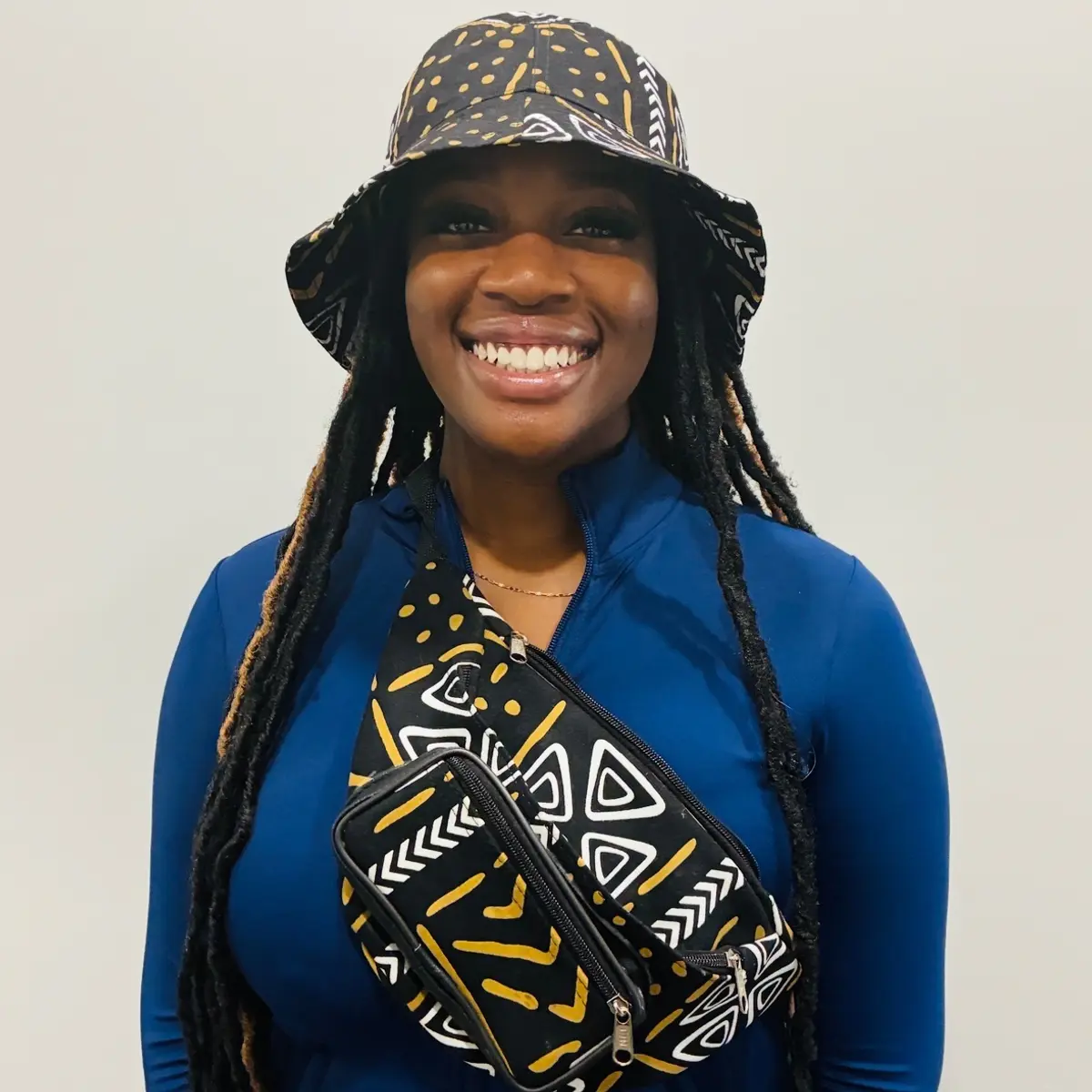 Wearing a handmade matching african print bucket hat & fanny pack