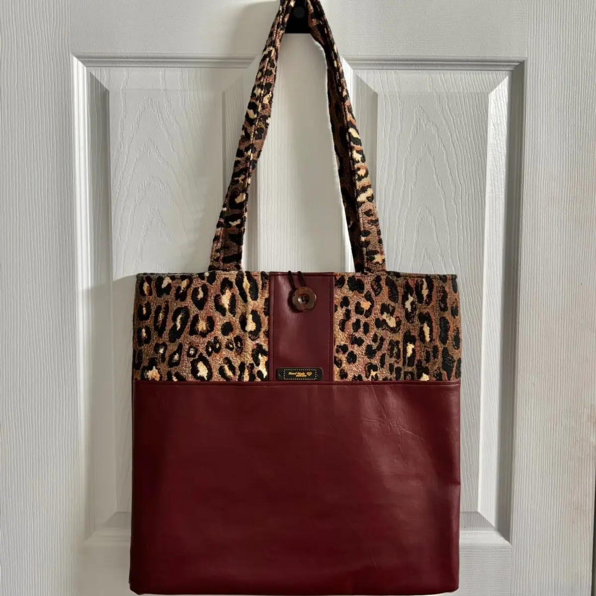 Front view of the handmade faux leather leopard print tote bag